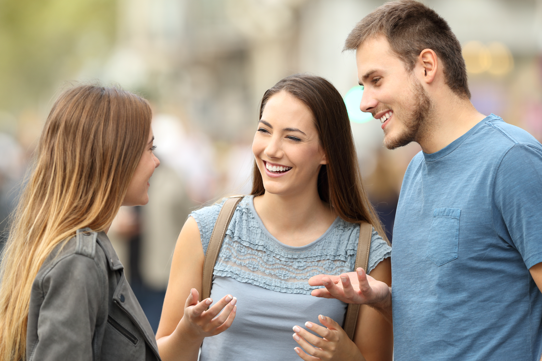 Two women and one male having a conversation